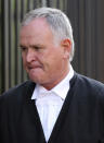 Barry Roux, the lawyer defending Oscar Pistorius, arrives at the high court in Pretoria, South Africa, Monday, March 24, 2014. The trial of Pistorius, who is charged with murder for the shooting death of his girlfriend Reeva Steenkamp on Valentines Day in 2013, is beginning its fourth week. The prosecution has said it will wrap up its case against the double-amputee runner this week after calling four or five more witnesses, beginning Monday. (AP Photo/Themba Hadebe)