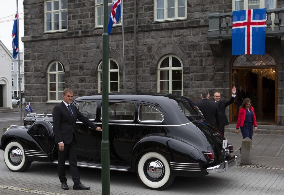 Iceland's president Guðni Th. Jóhannesson waves as he gets into a car following his inauguration in Reykjavik, Iceland Saturday Aug. 1, 2020. In Iceland, a nation so safe that its president runs errands on a bicycle, U.S. Ambassador Jeffery Ross Gunter has left locals aghast with his request to hire armed bodyguards. He's also enraged lawmakers by casually and groundlessly hitching Iceland to President Donald Trump's controversial "China virus” label for the coronavirus. (AP Photo/Árni Torfason)