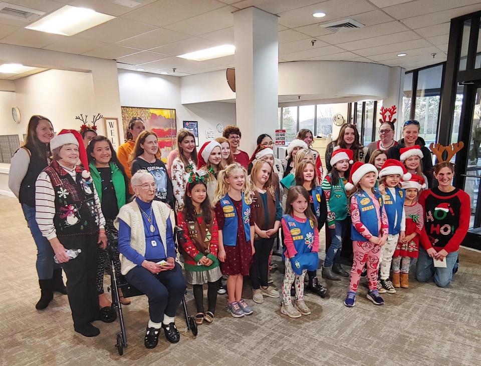 Girl Scouts and adult volunteers joined Eileen Neiler at Commonwealth Senior Living to honor her 100th birthday.