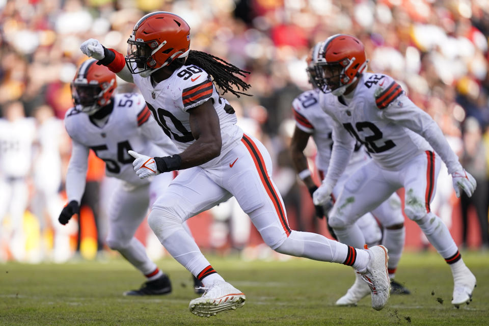 Cleveland Browns defensive end Jadeveon Clowney (90) rushes Washington Commanders quarterback Carson Wentz (11) during the first half of an NFL football game, Sunday, Jan. 1, 2023, in Landover, Md. (AP Photo/Patrick Semansky)