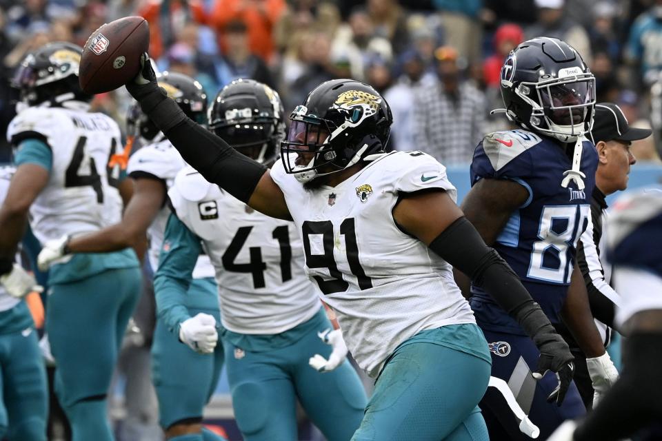 Jacksonville Jaguars defensive end Dawuane Smoot (91) celebrates after recovering a fumble by Tennessee Titans quarterback Ryan Tannehill during the first half of an NFL football game Sunday, Dec. 11, 2022, in Nashville, Tenn. (AP Photo/Mark Zaleski)