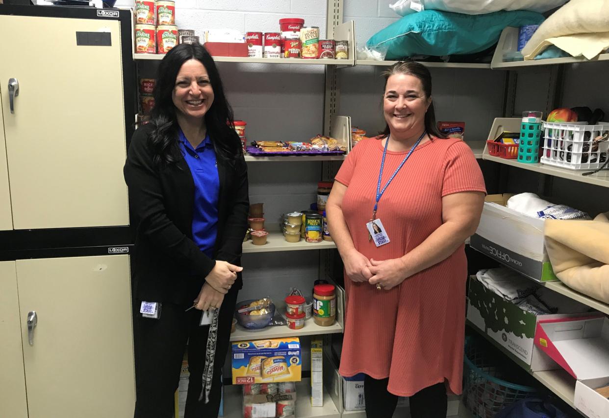 Student support liaisons Casey McVicker, left, and Heather Robertson, stand in the Bobcat Store at the high school, where students in need can stop by and pick up food items that can be taken home and fixed easily.