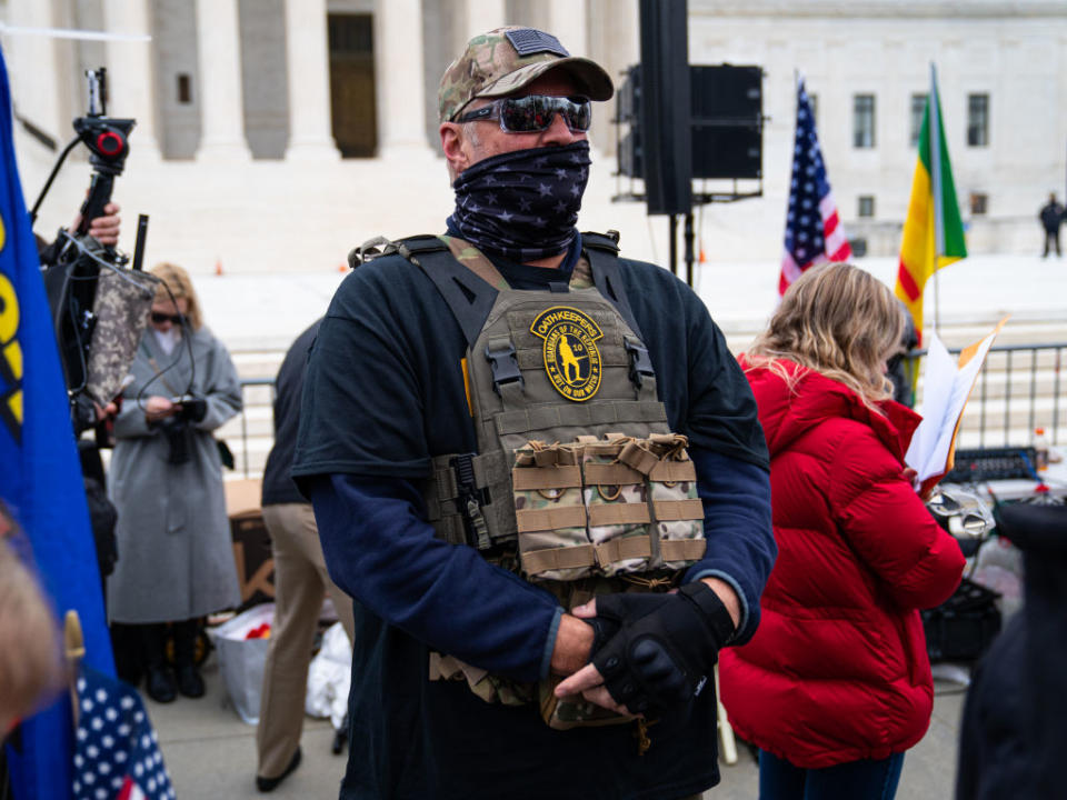 A member of the right-wing group Oath Keepers stands guard during a rally in front of the US Supreme Court Building in Washington, DC. 