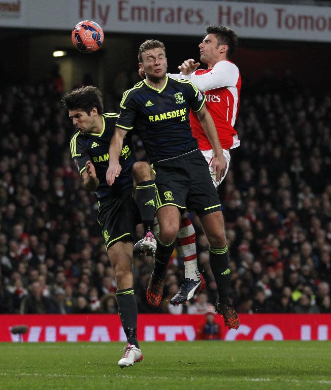 Arsenal's Olivier Giroud (R) fights for the ball with Middlesbrough's George Friend (L) and Ben Gibson during their English FA Cup match, at the Emirates Stadium in London, in February 2015