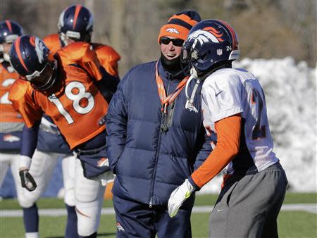 Denver Broncos head coach John Fox (C) talks with cornerback Champ Bailey (R) as quarterback Peyton Manning (18) exercises during stretching exercises in their practice session for the Super Bowl at the New York Jets Training Center in Florham Park, New Jersey, January 29, 2014. REUTERS/Ray Stubblebine