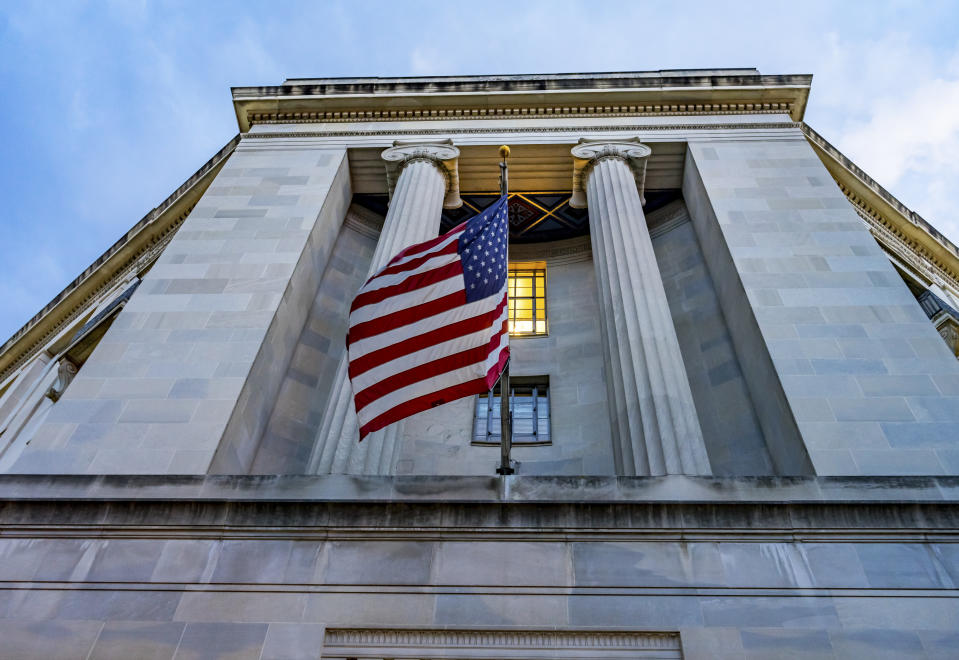 Facade FlagsJustice Department Building Pennsylvania Avenue Washington DC Completed in 1935. Houses 1000s of lawyers working at Justice.