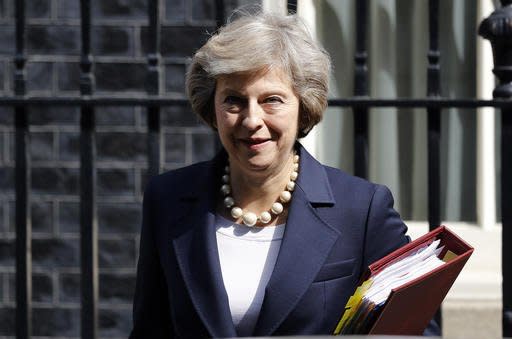 FILE- In this Wednesday, July 20, 2016 Britain's Prime Minister Theresa May leaves 10 Downing street for Prime Ministers Questions at the House of Parliament in London. ﻿Officials at May's Downing Street office say May is bringing her Cabinet together at her rural retreat, next Wednesday Aug. 31, 2016, to plot Britain's first steps on leaving the European Union. (AP Photo/Frank Augstein)