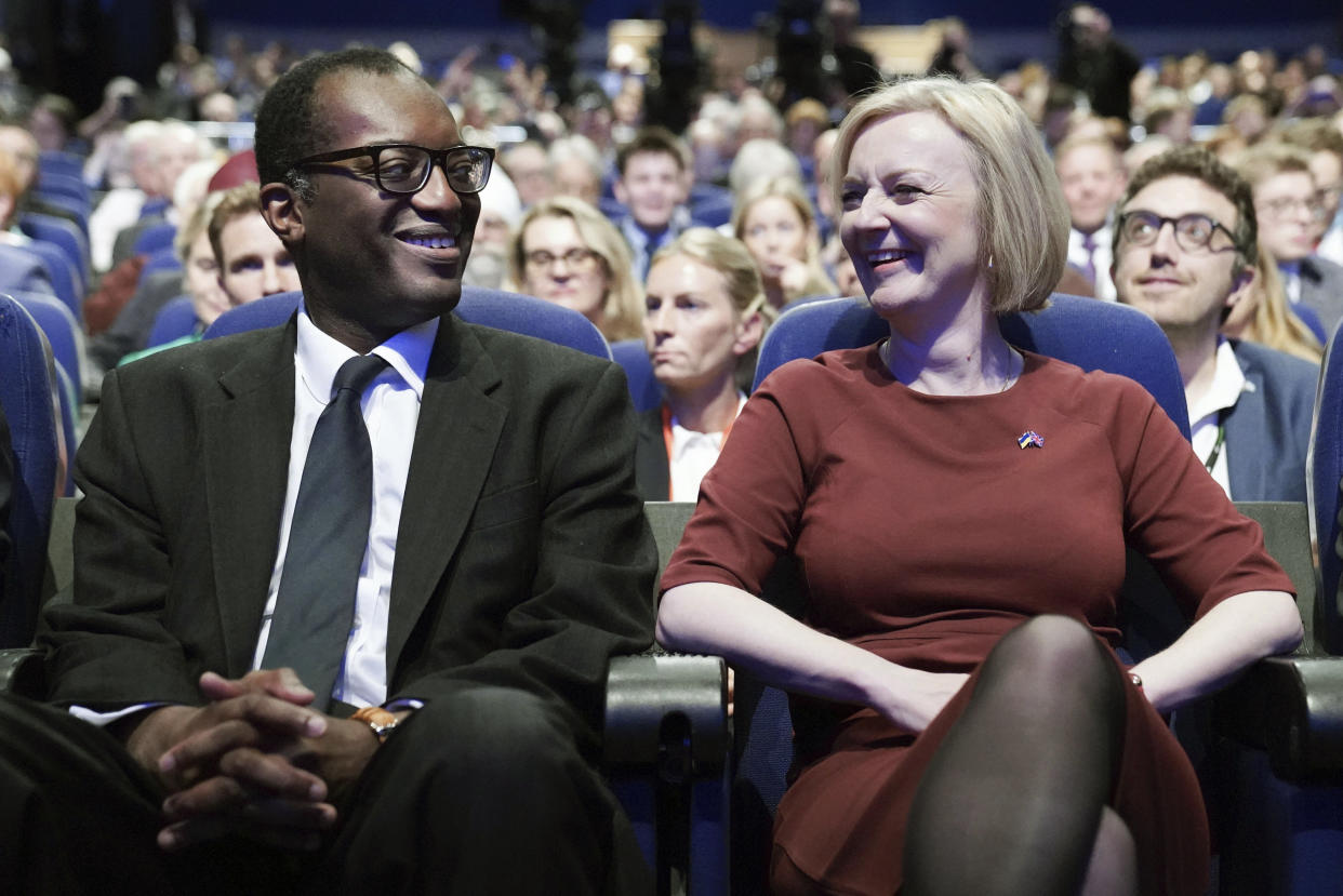 FILE - Britain's Chancellor of the Exchequer Kwasi Kwarteng, left and Prime Minister Liz Truss react, during a tribute to the late Queen Elizabeth II at the start of the Conservative Party annual conference in Birmingham, England, Ot. 2, 2022. British media on Friday, Oct. 14, 2022 say Treasury chief Kwasi Kwarteng has left the government, ahead of an announcement by Prime Minister Liz Truss on changes to an economic package that sparked market turmoil. (Stefan Rousseau/PA via AP, File)