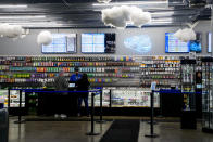 Cloud 9 Cannabis employee Kyler Hollingsworth checks out customers, Saturday, April 13, 2024, in Arlington, Wash. The shop is one of the first dispensaries to open under the Washington Liquor and Cannabis Board's social equity program, established in efforts to remedy some of the disproportionate effects marijuana prohibition had on communities of color. (AP Photo/Lindsey Wasson)