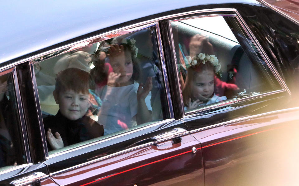 <p>The bridesmaids and page boys couldn’t help but stare at the crowds as they drove past. (Getty) </p>