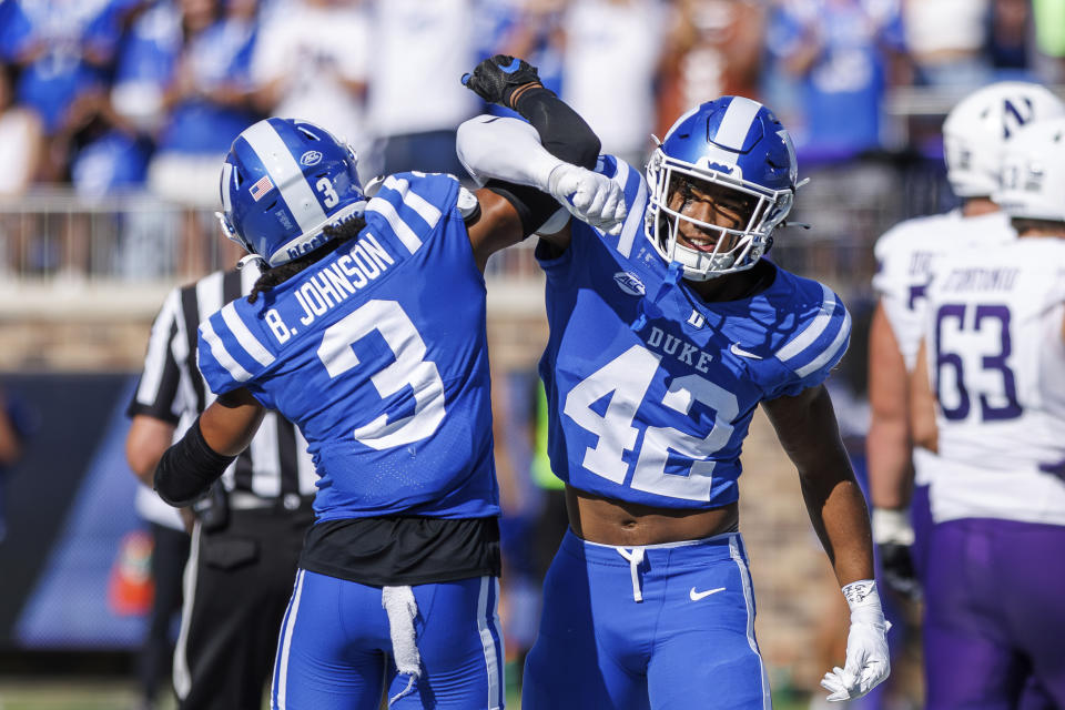 Duke's Kendall Johnson (42) and Brandon Johnson (3) celebrate after a play during the first half of an NCAA college football game against Northwestern in Durham, N.C., Saturday, Sept. 16, 2023. (AP Photo/Ben McKeown)