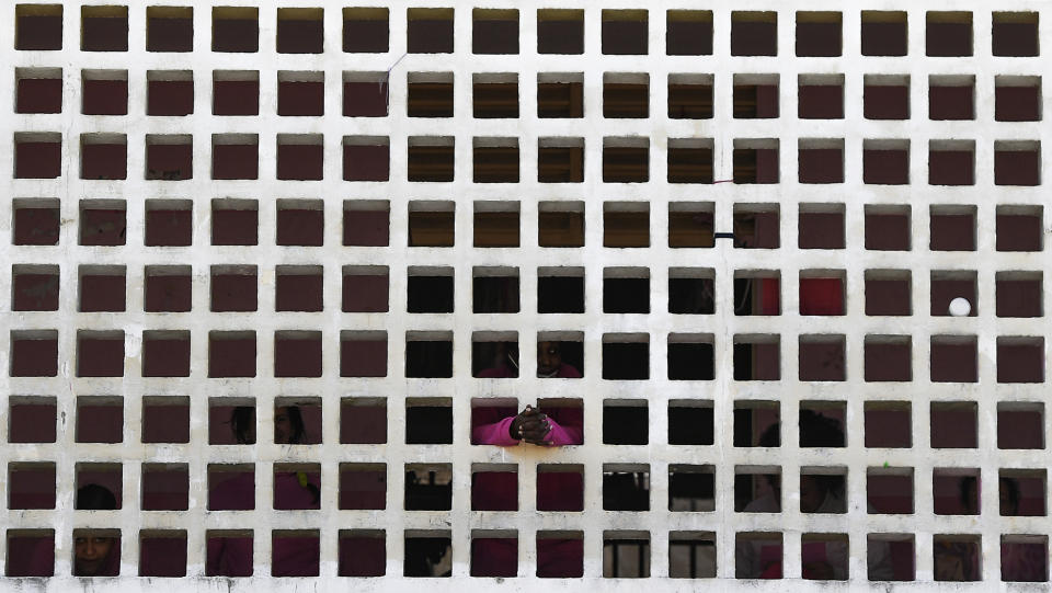 An inmate waits to be inoculated with a dose of the Sinopharm COVID-19 vaccine during a vaccination campaign at the women's prison in Los Teques, Miranda state, Venezuela, Friday, July 2, 2021. (AP Photo/Matias Delacroix)