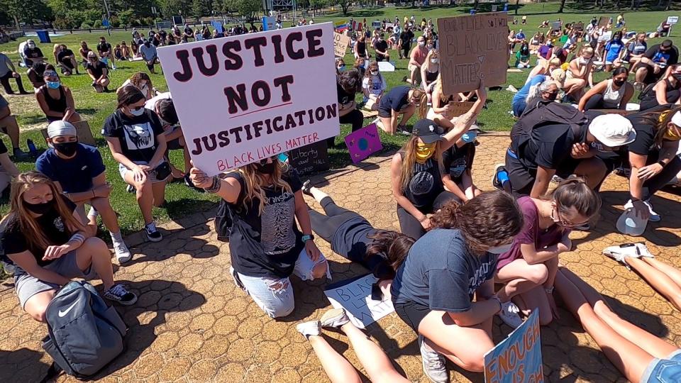 Ralliers take a knee at Windward Beach in Brick Township in June 2020 to protest deaths in police custody.