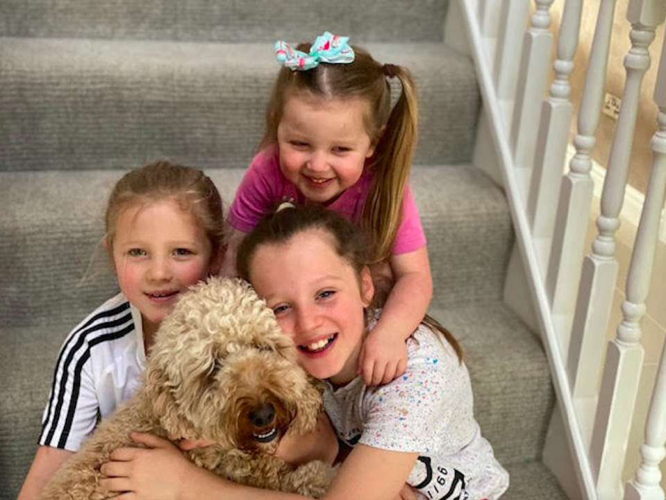 Benji the dog with (L-R) Scarlett Malley, Seren Malley (back) and Sienna Malley. (SWNS)