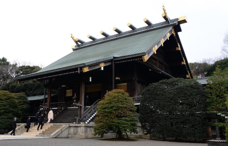 A Shinto priest leads Japanese officials to the altar at the controversial Yasukuni war shrine in Tokyo, on December 26, 2013