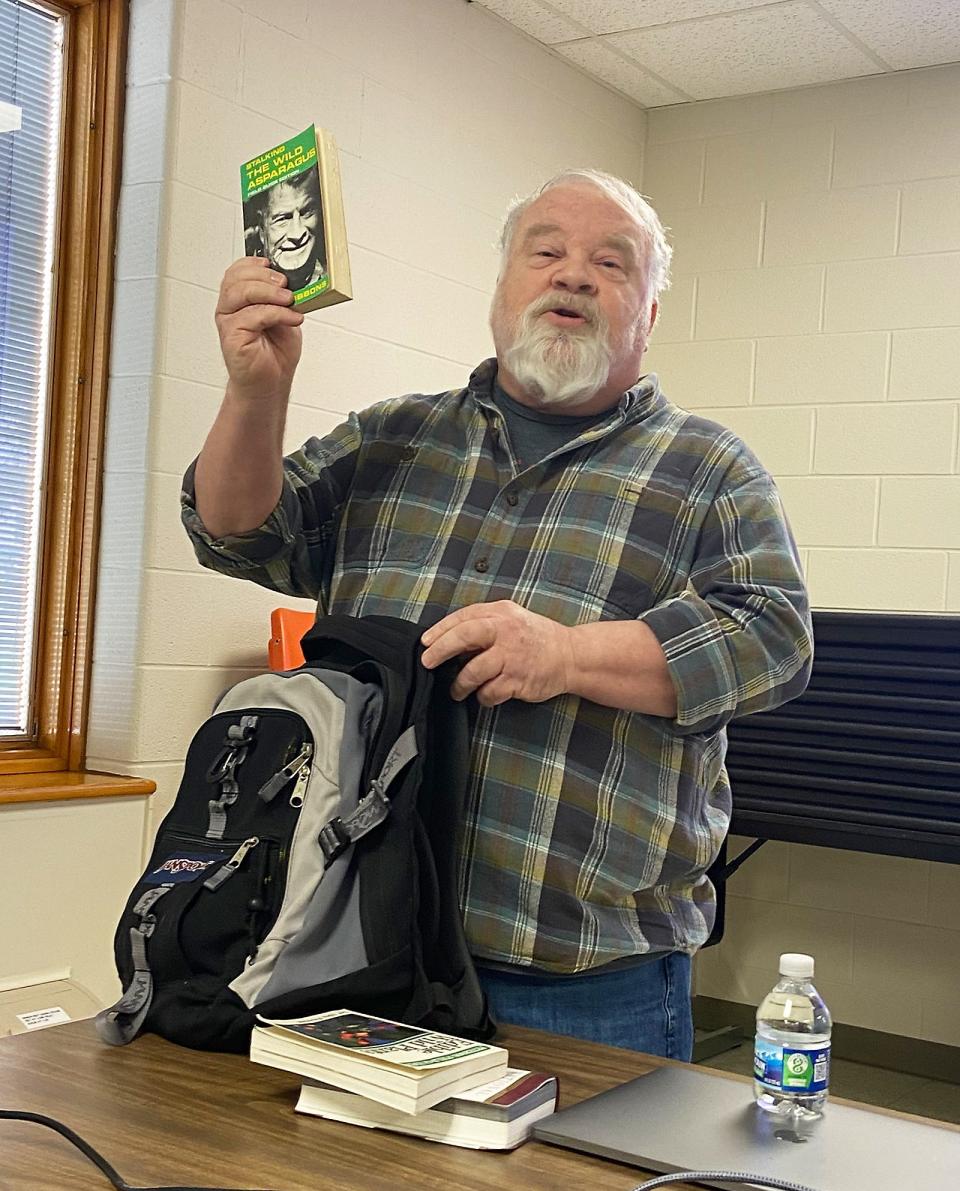 Mike Reid shows items he keeps in a backpack in his vehicle for foraging, including several books, a knife, scissors, a mesh bag and more. Foraging is more fun when you’re prepared, he said.
