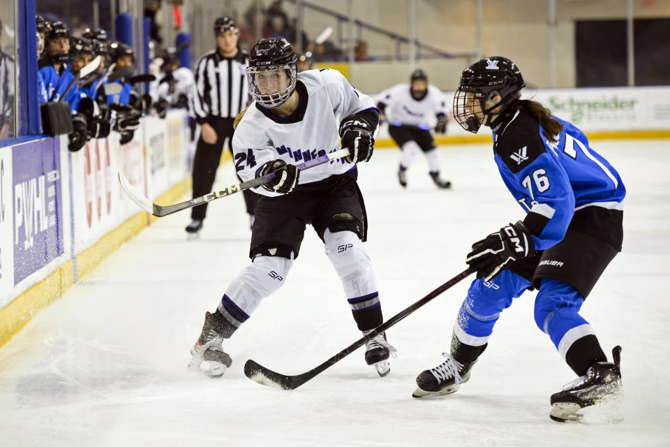 Minnesota forward Abby Boreen (24) plays the puck along the boards as Toronto defender Maude Poulin-Labelle (76) skates in during the first period of a PWHL hockey game in Toronto, Ontario, Saturday, Feb. 3, 2024. (Christopher Katsarov/The Canadian Press via AP)