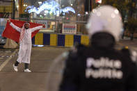 FILE - Police riot officers face Morocco fans celebrating their victory at the World Cup group F soccer match between Canada and Morocco, in Brussels, Thursday, Dec. 1, 2022. (AP Photo/Geert Vanden Wijngaert, File)