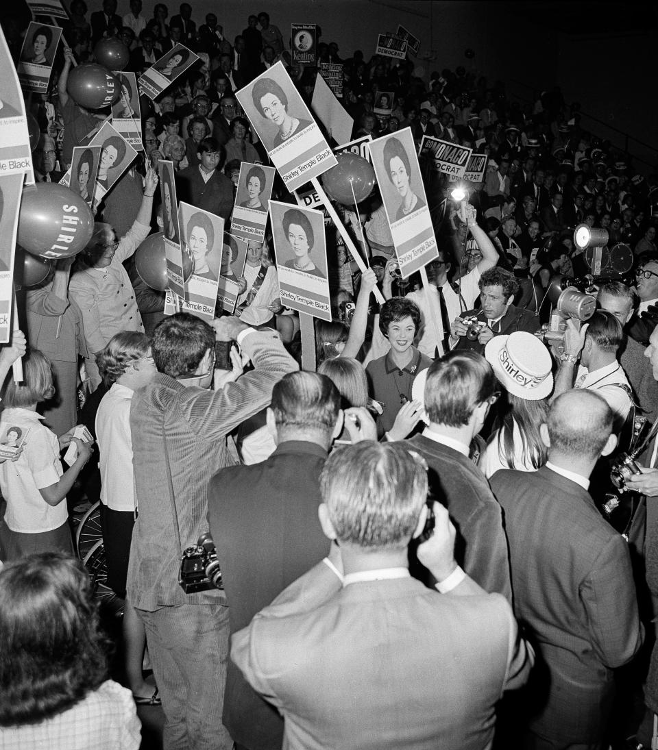 In this Nov. 10, 1967, file photo, Shirley Temple Black is surrounded by a group of supporters as she arrives for a debate with four Democratic candidates for the right to represent the 11th Congressional District, at El Camino High School gymnasium, in San Francisco. Temple, who died at her home near San Francisco, Monday, Feb. 10, 2014, at 85, sang, danced, sobbed and grinned her way into the hearts of Depression-era moviegoers and remains the ultimate child star decades later. (AP Photo/Robert Houston, File)