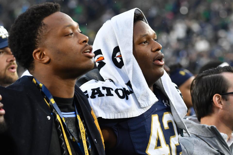 Notre Dame's Julian Okwara (42) and his brother, Detroit Lions player Romeo Okwara, sing the Notre Dame Alma Mater after the Irish defeated Bowling Green at Notre Dame Stadium, Oct. 5, 2019 in South Bend, Ind.