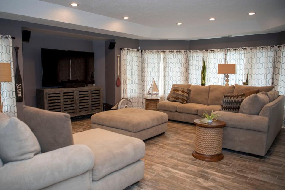 The living room at 265 Lakeshore Drive, an island home on Goguac Lake in Battle Creek, is pictured on Wednesday, May 4, 2022.