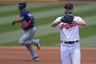 Cleveland Indians starting pitcher Logan Allen waits for Minnesota Twins' Josh Donaldson (20) to run the bases after hitting a solo home run in the first inning of a baseball game, Wednesday, April 28, 2021, in Cleveland. (AP Photo/David Dermer)