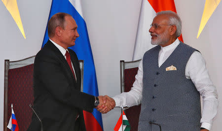 Russian President Vladimir Putin (L) shakes hands with India's Prime Minister Narendra Modi during exchange of agreements event after India-Russia Annual Summit in Benaulim, in the western state of Goa, India, October 15, 2016. REUTERS/Danish Siddiqui