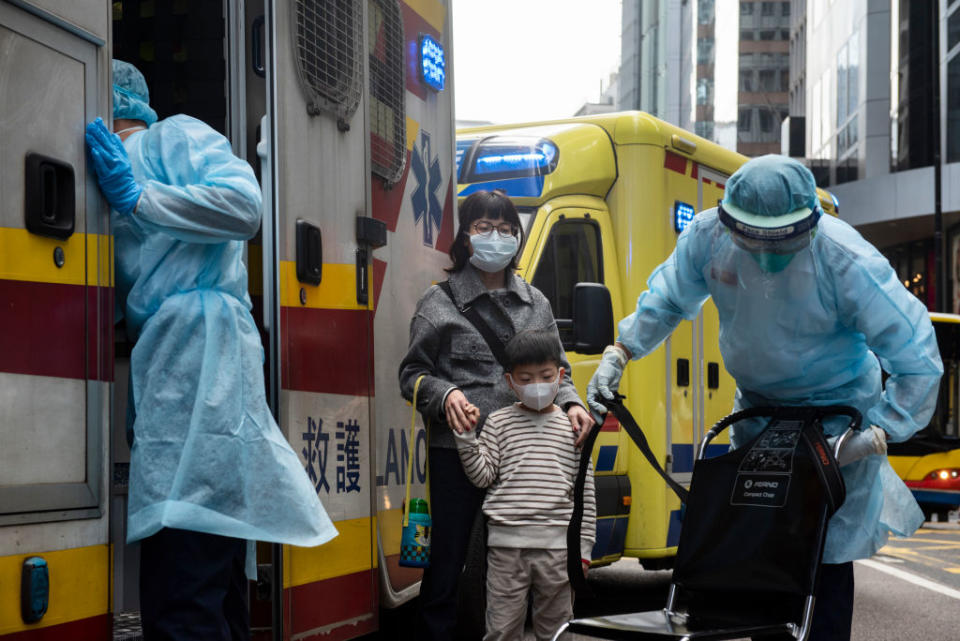 Health care members make first aid to people as they cover their faces with sanitary masks. Source: Getty