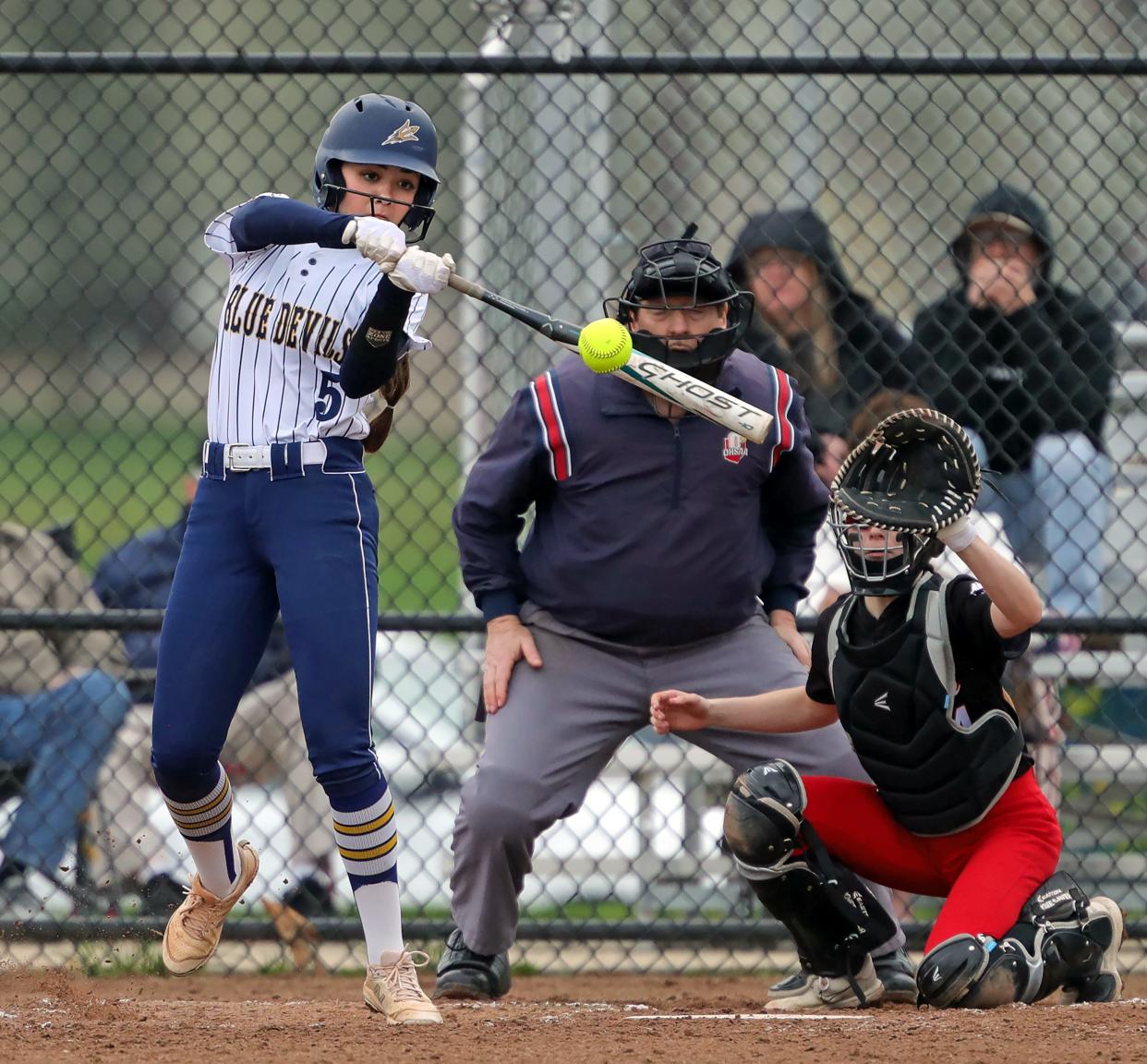 Tallmadge's Leila Staszak, left, connects for an RBI single against Kent Roosevelt on April 10 in Tallmadge.