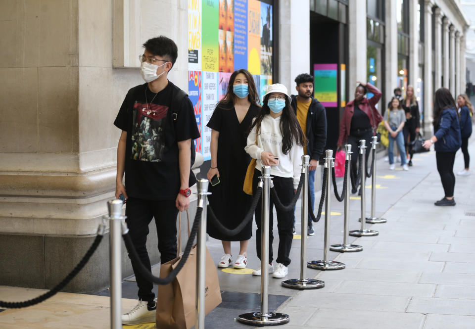 Shoppers queue outside department store Selfridges on Oxford Street, London, as non-essential shops in England open their doors to customers for the first time since coronavirus lockdown restrictions were imposed in March. Picture date: Monday June 15, 2020.