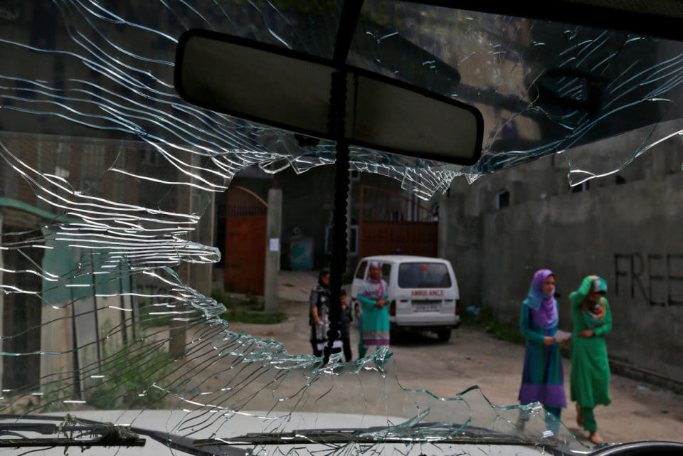 Women leave a hospital in Srinagar as the city remains under curfew following weeks of violence in Kashmir