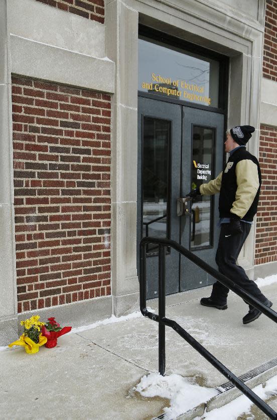 A student enters the Electrical Engineering building as it was reopened on Wednesday, Jan. 22, 2014, on the campus of Purdue University, in West Lafayette, Ind. The building had been closed since engineering student Andrew Boldt was shot and killed Tuesday at the Electrical Engineering building. Cody Cousins, a student, has been charged in the shooting. (AP Photo/Journal & Courier, John Terhune)