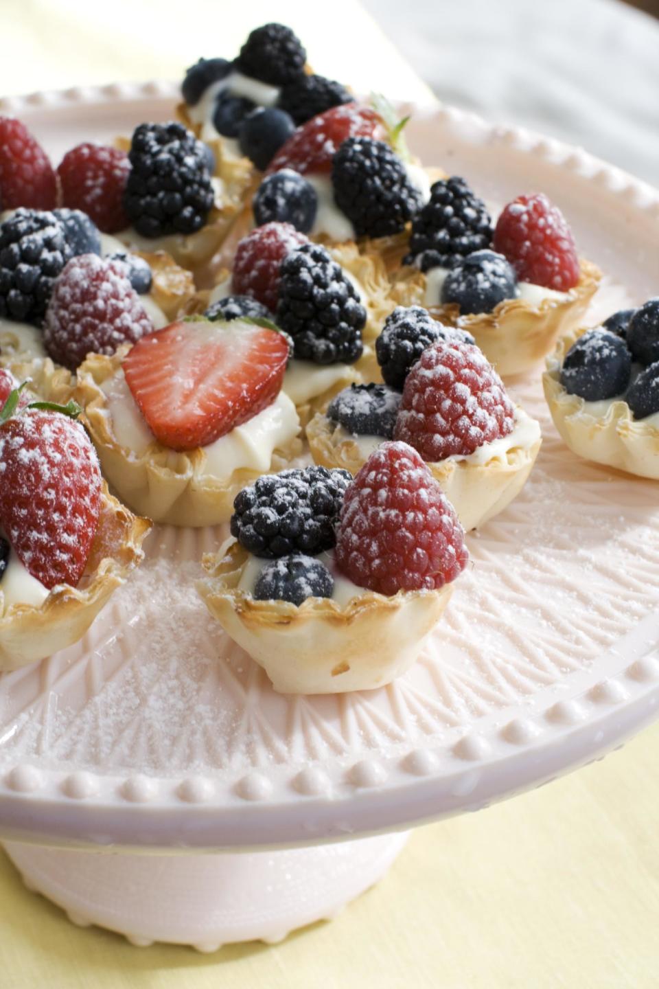 In this image taken on March 4, 2013, creamy lemon-berry tartlets are shown served on a dessert stand in Concord, N.H. (AP Photo/Matthew Mead)