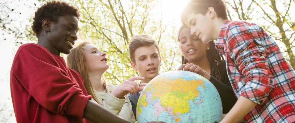 Multiracial Teen Couple Holding Globe Map - stock