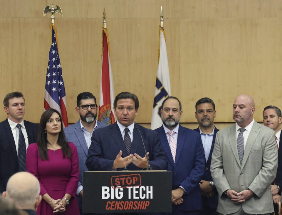 Florida Gov. Ron DeSantis gives his opening remarks flanked by local state delegation members prior to signing legislation that seeks to punish social media platforms that remove conservative ideas from their sites, inside Florida International University's MARC building in Miami on Monday, May 24, 2021. (Carl Juste/Miami Herald via AP)