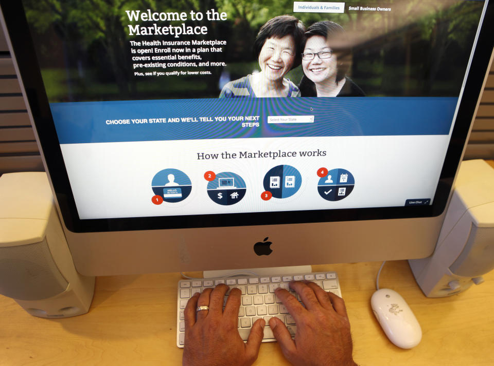 A man looks over the Affordable Care Act (commonly known as Obamacare) signup page on the HealthCare.gov website in New York in this October 2, 2013 photo illustration. The federal government's portal logged over 2.8 million visitors by afternoon October 2, largely in an attempt to sign up for Obamacare.  REUTERS/Mike Segar  (UNITED STATES - Tags: HEALTH SOCIETY POLITICS)