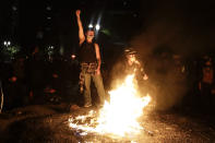 Demonstrators rally around a fire during a Black Lives Matter protest at the Mark O. Hatfield United States Courthouse Saturday, July 25, 2020, in Portland, Ore. (AP Photo/Marcio Jose Sanchez)