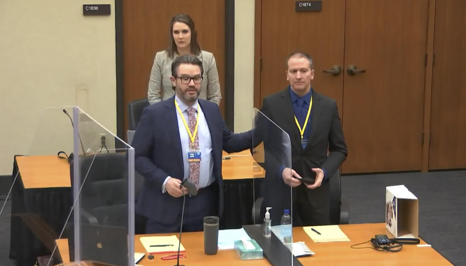 In this screen grab from video, defense attorney Eric Nelson, left, defendant and former Minneapolis police officer Derek Chauvin, right, and Nelson's assistant Amy Voss, back, introduce themselves to potential jurors as Hennepin County Judge Peter Cahill Tuesday, March 23, 2021, presides over jury selection in the trial of Chauvin at the Hennepin County Courthouse in Minneapolis, Minn. Chauvin is charged in the May 25, 2020 death of George Floyd. (Court TV, via AP, Pool)