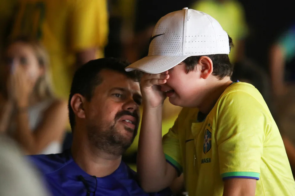 Brazilian fans react as they watch the FIFA World Cup Qatar 2022 match between Brazil and Croatia at a bar in Santos, Brazil, December 9, 2022. REUTERS/Carla Carniel