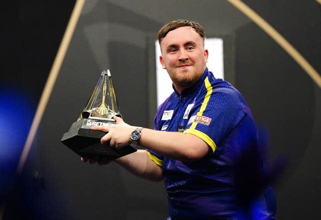 Luke Littler holds the trophy after winning the Premier League