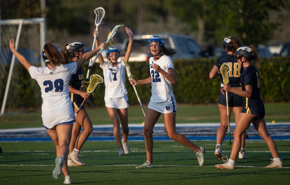 Stella Lynch #22 of the Community School of Naples Lacrosse team celebrates a goal over Naples during a district game at CSN on Thursday, April 18, 2024. CSN won.