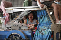 Residents evacuate as Taal Volcano erupts Sunday Jan. 12, 2020, in Tagaytay, Cavite province, outside Manila, Philippines. A tiny volcano near the Philippine capital that draws many tourists for its picturesque setting in a lake belched steam, ash and rocks in a huge plume Sunday, prompting thousands of residents to flee and officials to temporarily suspend flights. (AP Photo/Aaron Favila)