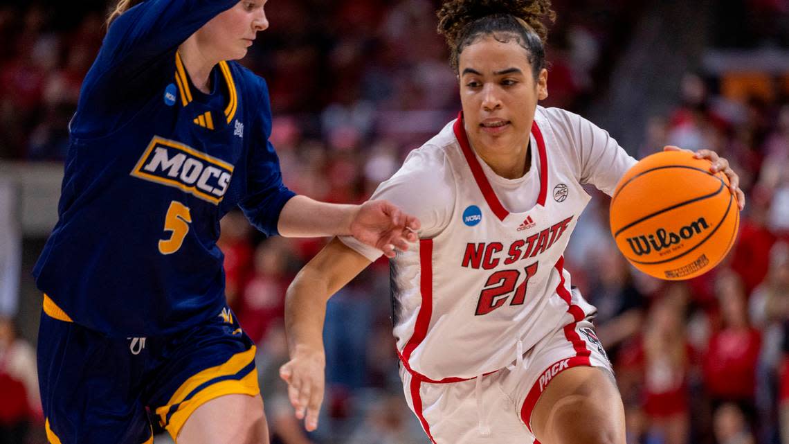 NC State’s Madison Hayes (21) looks for room against Chattanooga’s Sigrun Olafsdottir (5) during the second half of the first round of the NCAA Division I Women’s Basketball Championship at Reynolds Coliseum in Raleigh, NC on Saturday, March 23, 2024. N.C. State won 64-45.