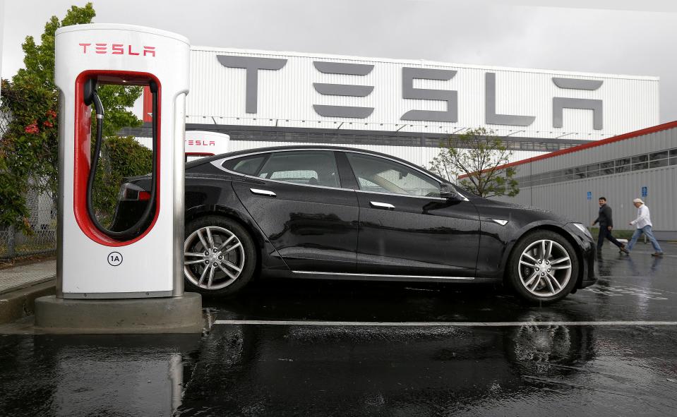 Tesla electric vehicle connected to a charging station outside the Tesla factory in Fremont, Calif., on May 14, 2015.