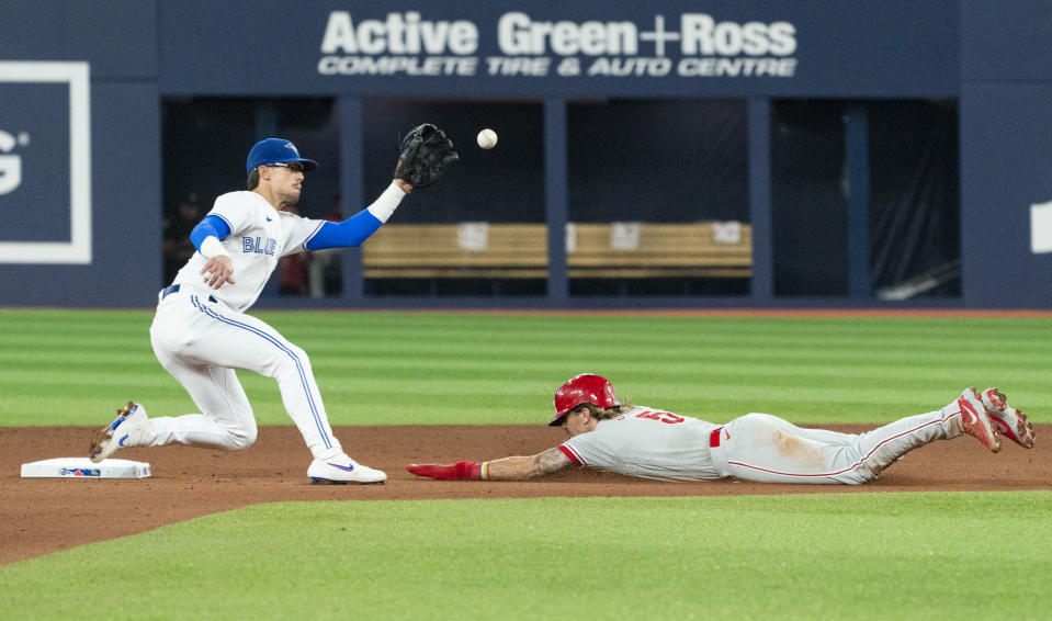 Philadelphia Phillies' Bryson Stott steals second base ahead of the throw to Toronto Blue Jays second baseman Cavan Biggio during the seventh inning of a baseball game Tuesday, Aug. 15, 2023, in Toronto. (Nathan Denette/The Canadian Press via AP)