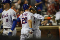 New York Mets' Francisco Lindor, right, celebrates with Pete Alonso, center, after hitting a grand slam during the sixth inning of a baseball game against the Pittsburgh Pirates Friday, July 9, 2021, in New York. (AP Photo/Frank Franklin II)