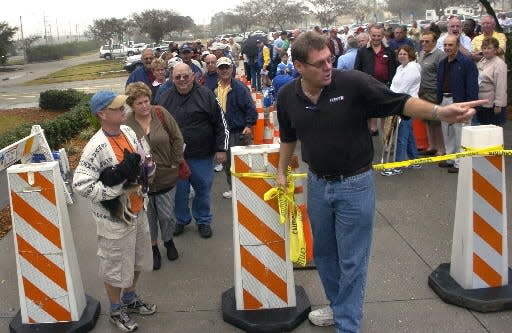 Pat Calhoon, sports facility manager for the City of Sarasota, points the way to spring training tickets for fans who waited in line at Ed Smith Sadium on Jan., 19, 2008. HERALD-TRIBUNE FILE PHOTO