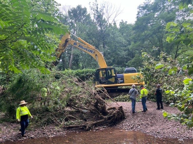 These photos taken on July 20-21, 2023 show excavators carefully disassembling the largest, densest debris piles in Houghs Creek between River and Taylorsville roads. These piles were too large do be done by hand.