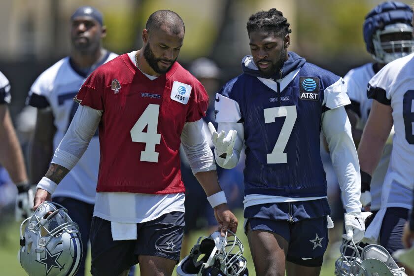 Dallas Cowboys quarterback Dak Prescott, left, and cornerback Trevon Diggs have a conversation