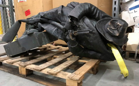 A damaged nearly century-old Confederate statue lies on a pallet in a warehouse in Durham, N.C. on Tuesday, Aug. 15, 2017 - Credit: AP